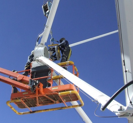 Engineers installing a PI hexapod at a subreflector of an ALMA telescope